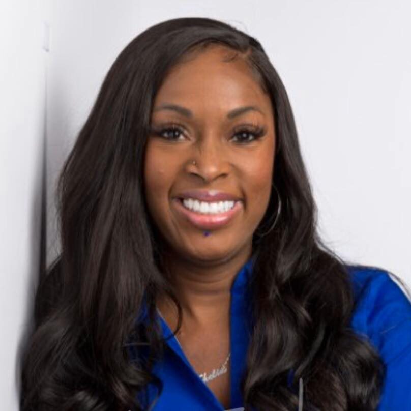 Shelia Long smiling, in a royal blue blouse
